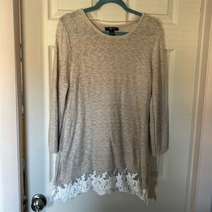This sweater is a longer style with a 3.5 inches lace across the hem